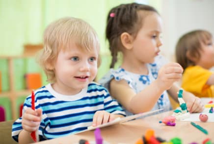 Kids making arts and crafts in day care centre together