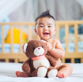 toddler playing with his teddy bear