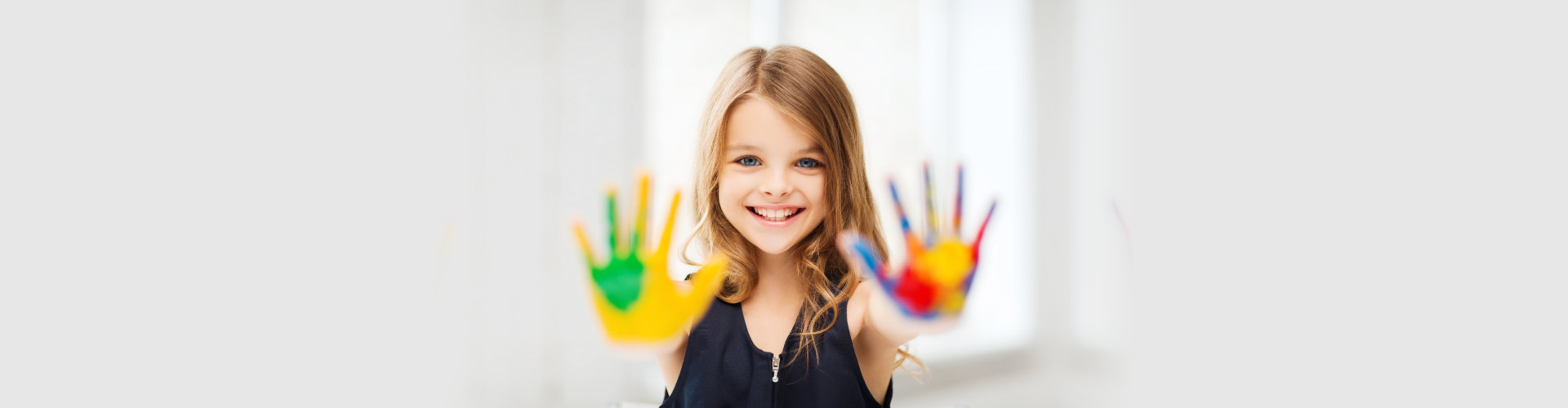 Smiling girl showing painted hands