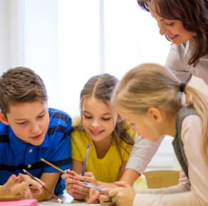 Group of school kids writing test in classroom