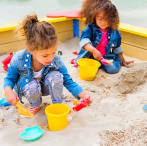 2 little girls playing with sand