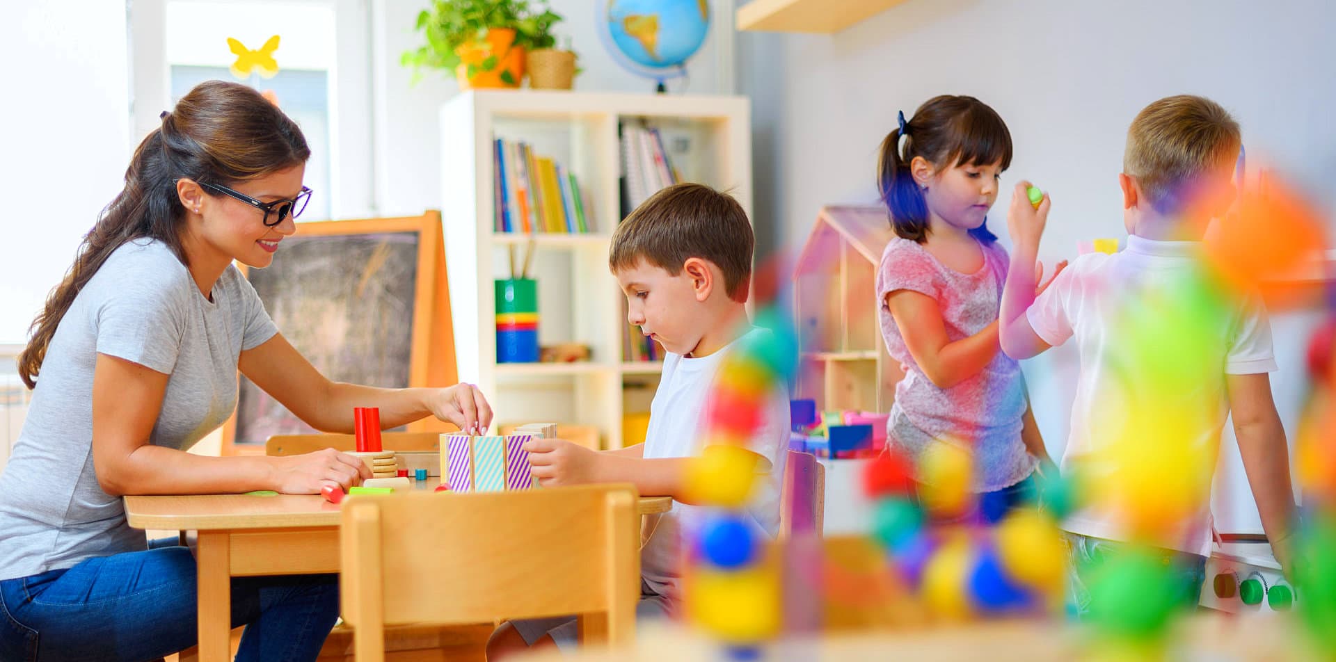 woman supervising children playing