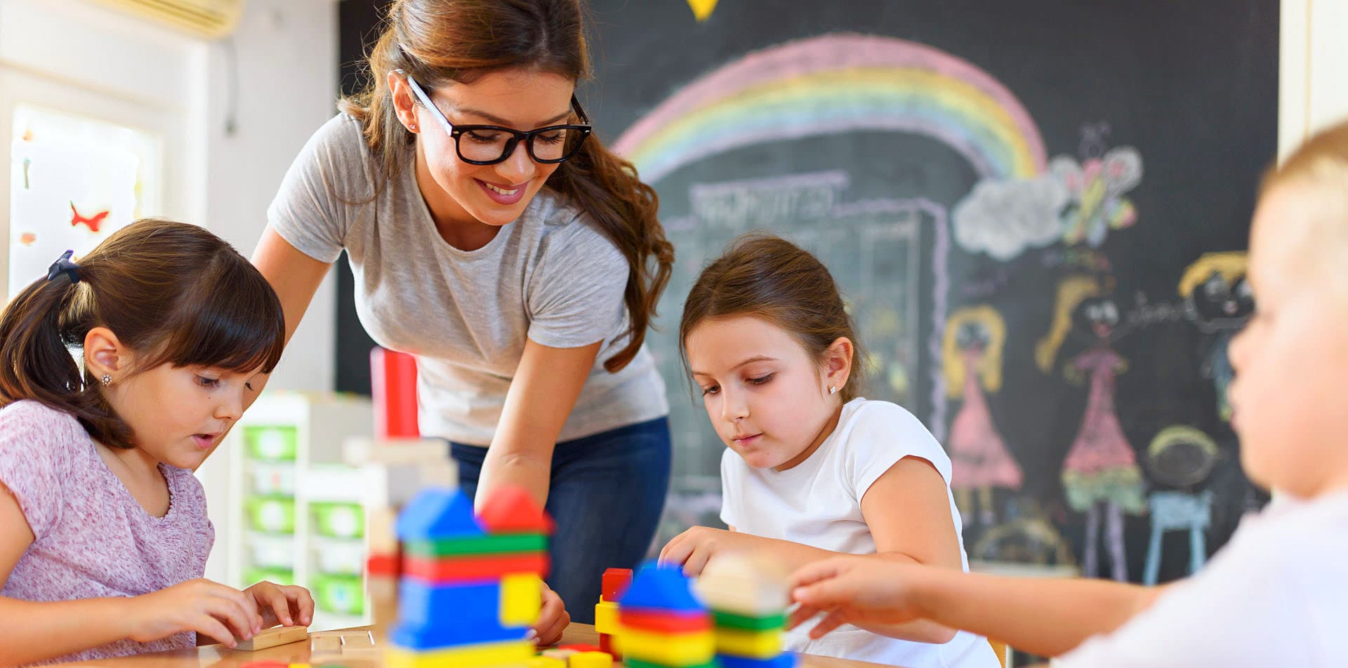 woman supervising children playing