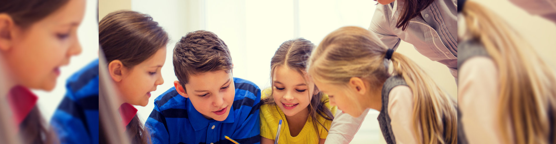group of school kids writing test in classroom