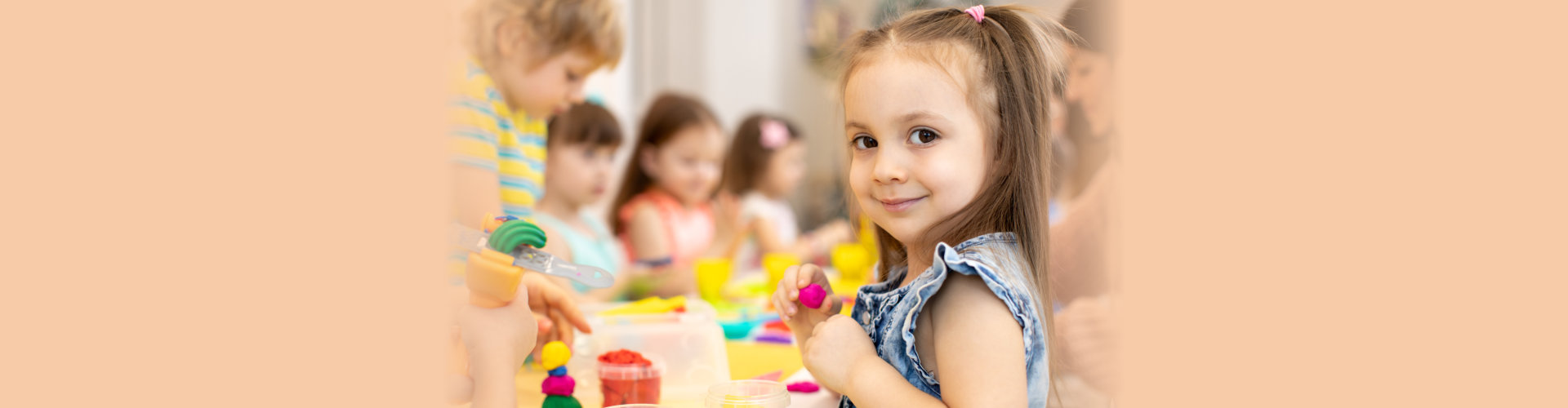Happy kids doing arts and crafts in day care centre